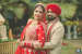 Crimson Red Lehenga of the Bride Complementing the Cream Sherwani of the Groom by Priyanka Kamboj Wedding-photography Groom-wear-and-accessories Bridal-makeup | Weddings Photos & Ideas