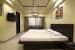 Simple Bedroom with Wooden Finished Queen Size Bed and Marble Flooring by Trupti Ladda Bedroom Minimalistic | Interior Design Photos & Ideas