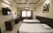 Basic Bedroom with Wood Finished Single Beds and Wooden Display Unit by Trupti Ladda Bedroom Minimalistic | Interior Design Photos & Ideas