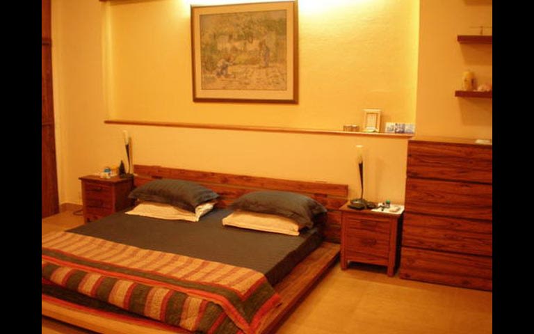 Simple Bedroom with Wooden Furniture by Vimi Rath Bedroom Contemporary | Interior Design Photos & Ideas