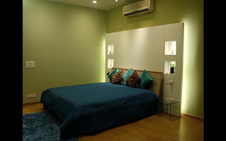 Bedroom with Wooden Flooring and Green Walls by Vimi Rath Bedroom Modern | Interior Design Photos & Ideas