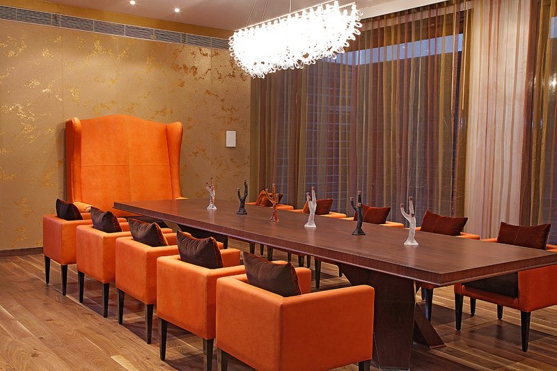 Dining Room With Wooden Table And Orange Tub Chairs by Ishika singh Dining-room Contemporary | Interior Design Photos & Ideas