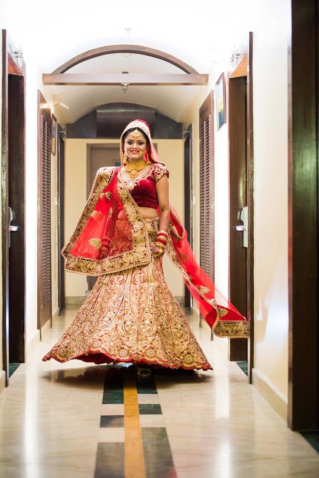 Bride Wearing A Stunning Red Lehenga With Gold Work by Saurabh Wedding-photography Wedding-dresses | Weddings Photos & Ideas