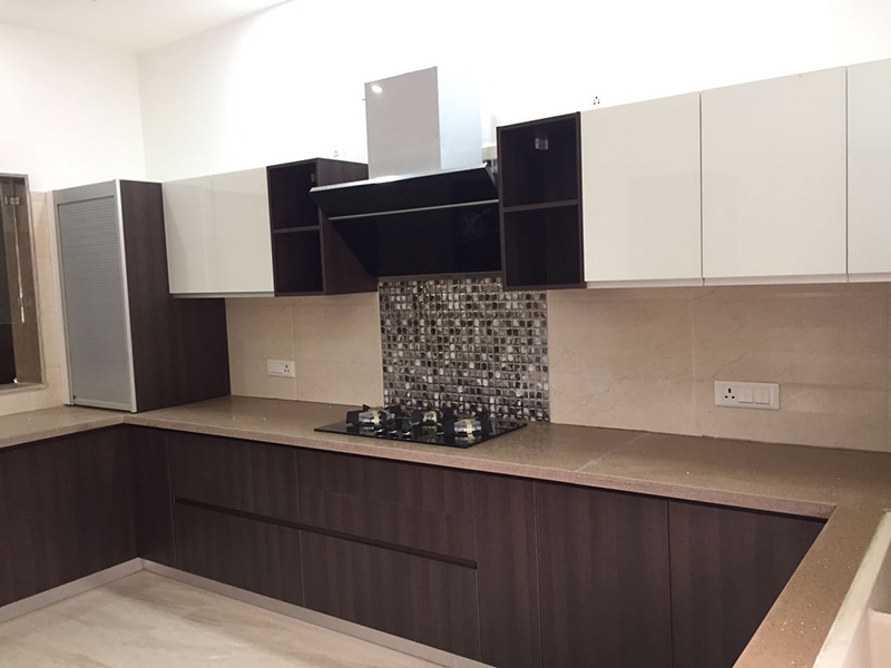 U-shaped modular kitchen design with wooden finish cabinets by Interior