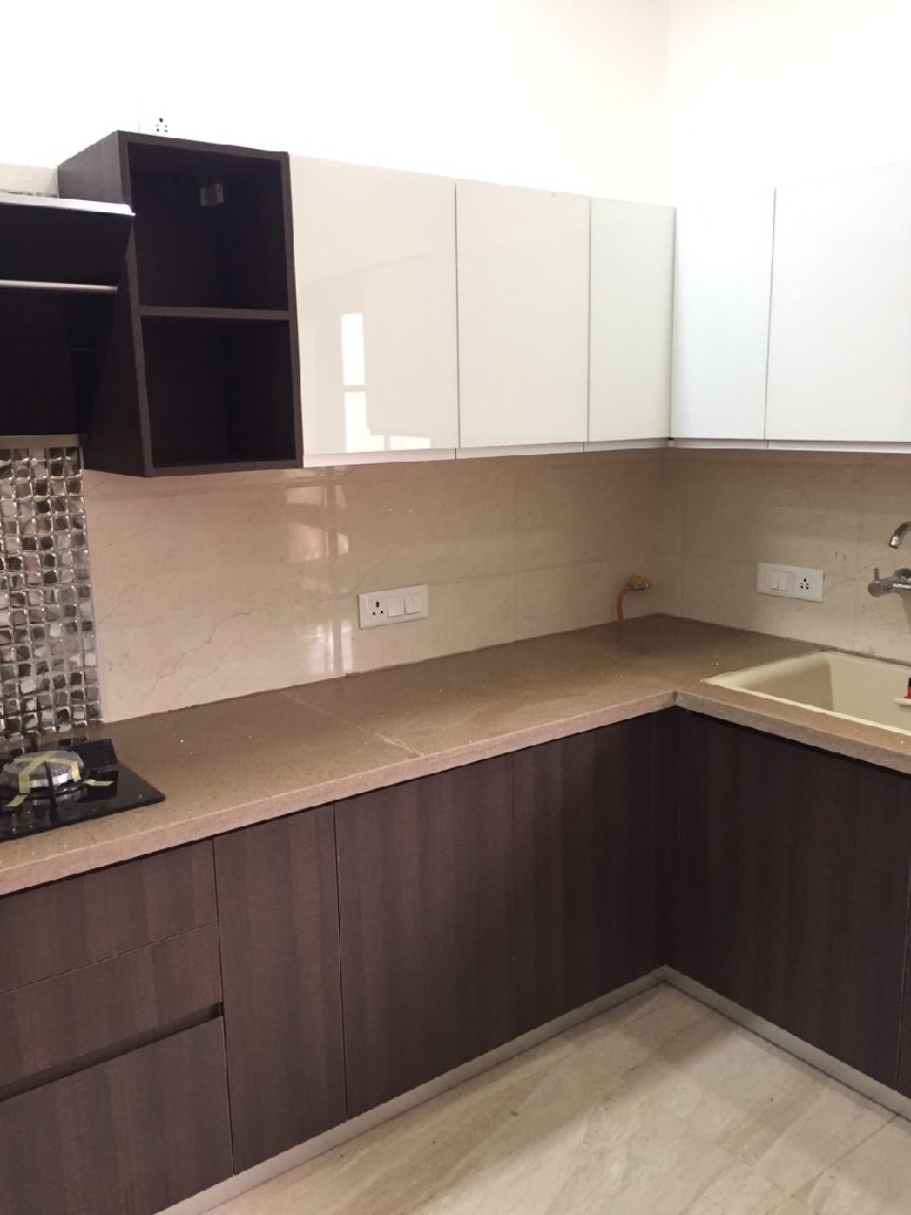 L-shaped modular kitchen design with wooden finish cabinets by Interior Design Modular-kitchen | Interior Design Photos & Ideas