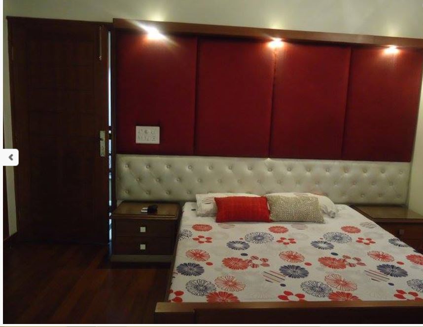 A Red-Themed Bedroom with Wood Flooring and Queen Size Bed by Chetan Chanana Bedroom Modern | Interior Design Photos & Ideas