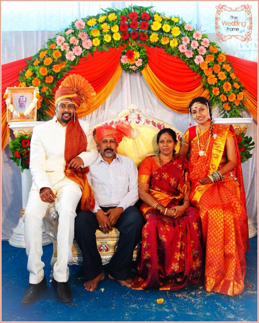 Bride and Groom Family Shot Against Floral Decor by The Wedding Frames Wedding-photography | Weddings Photos & Ideas