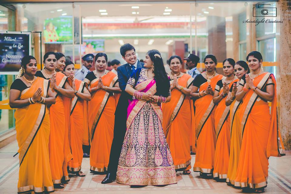 Bride and Groom Posing With Bridesmaid Wearing Orange Sarees by Gracian Wedding-photography | Weddings Photos & Ideas