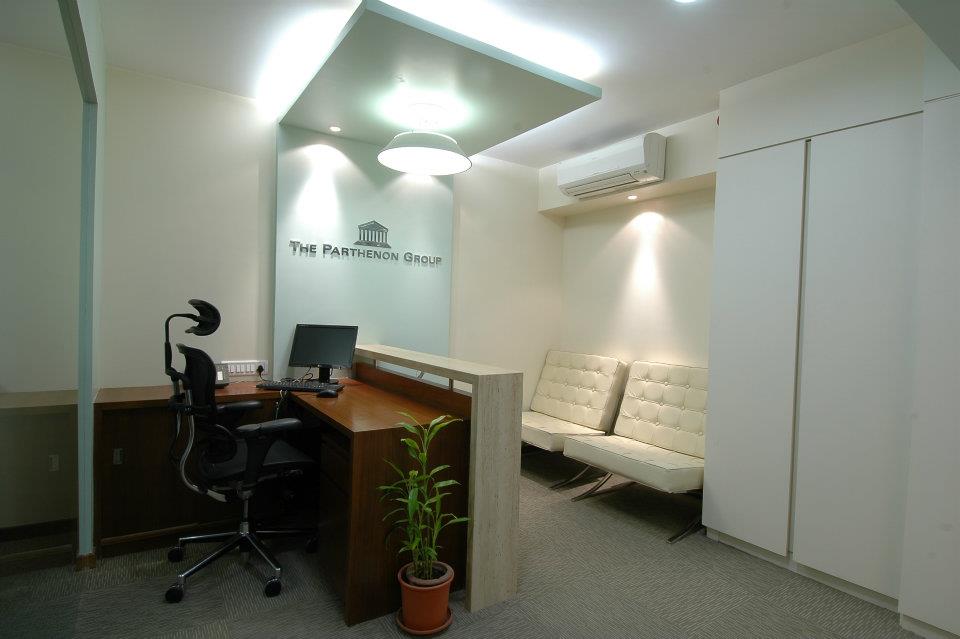 Office Reception Area With Wooden Desk And White Sofa by Hoshedaar Eruch Carnac Modern | Interior Design Photos & Ideas