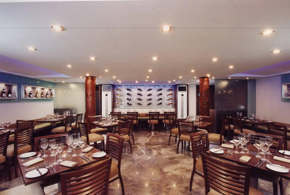 Restaurant With Shades Of Brown And Wooden Table and Chair by Hoshedaar Eruch Carnac Contemporary | Interior Design Photos & Ideas