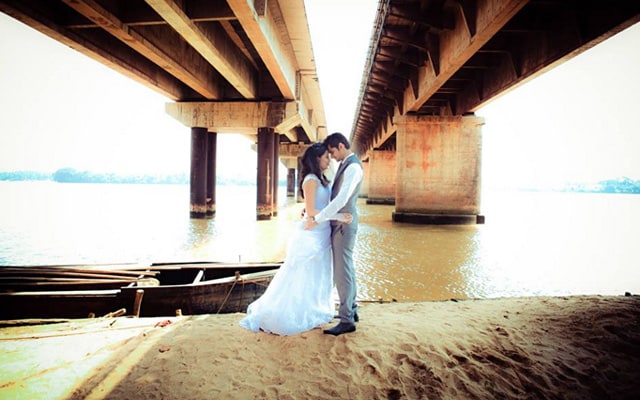 Bride and Groom Strike a Romantic Pose Under the Bridge by Bosco Naveen Wedding-photography | Weddings Photos & Ideas
