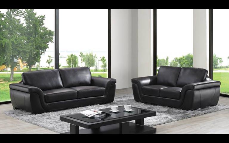 Spacious Living Area With Tufted Sofa And Soft Rug by Swagita Modern | Interior Design Photos & Ideas
