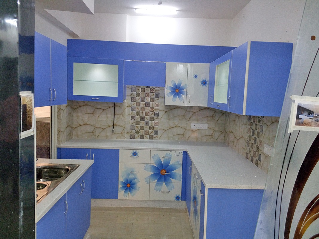 L shaped Kitchen with Blue and White theme and Floral Designs on Cabinets by Ar. Barkha Jain Modular-kitchen Modern | Interior Design Photos & Ideas
