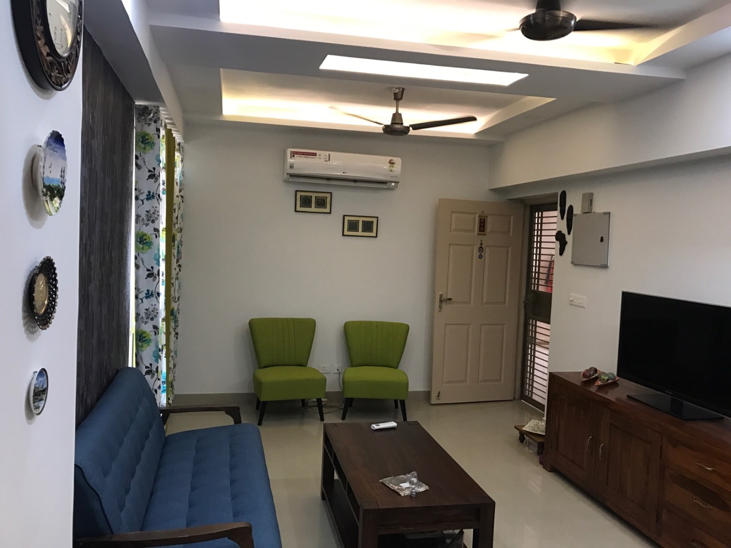 Simple living room with Blue Sofa and Green Cushioned Chairs by Ar. Barkha Jain Living-room Modern | Interior Design Photos & Ideas