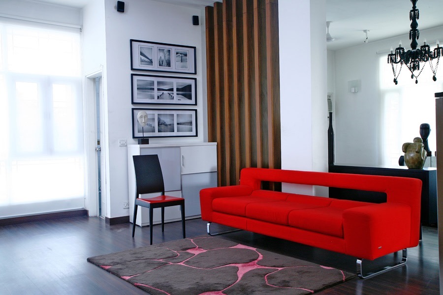 White Themed Living Room With Red Mid Century Sofa And Rustic Candle Style Chandelier by Yogesh Goel Living-room Eclectic | Interior Design Photos & Ideas