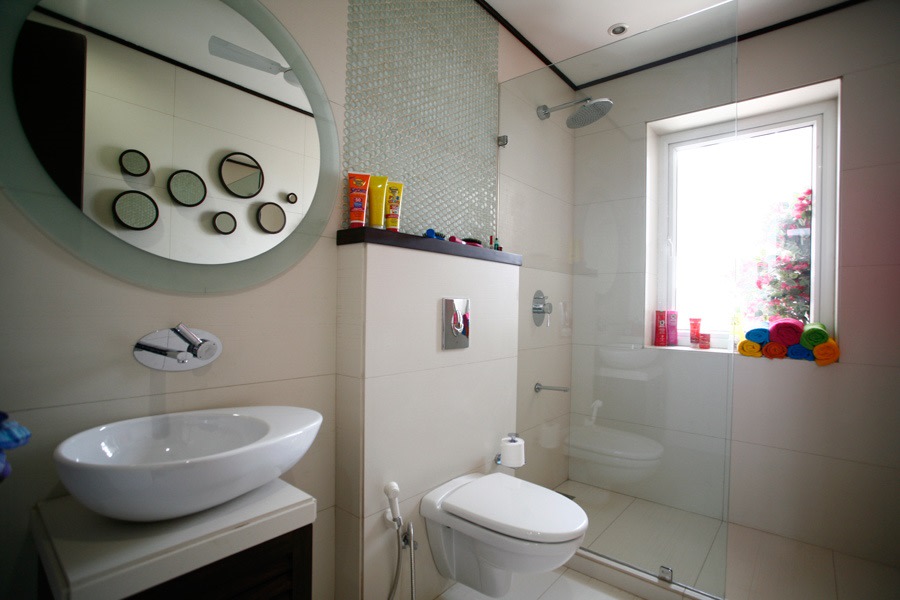 White Themed Bathroom , Circular Mirror And Glass Shower Enclosure by Yogesh Goel Bathroom Minimalistic | Interior Design Photos & Ideas