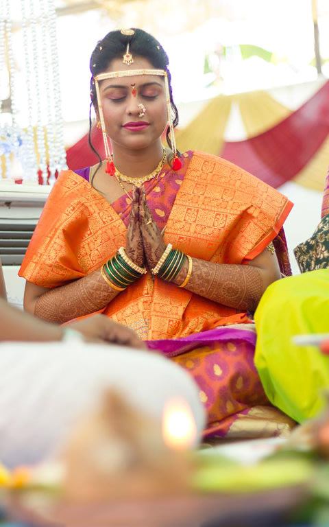 A candid picture of the bride praying by Pankaj Rokade Photography Wedding-photography | Weddings Photos & Ideas
