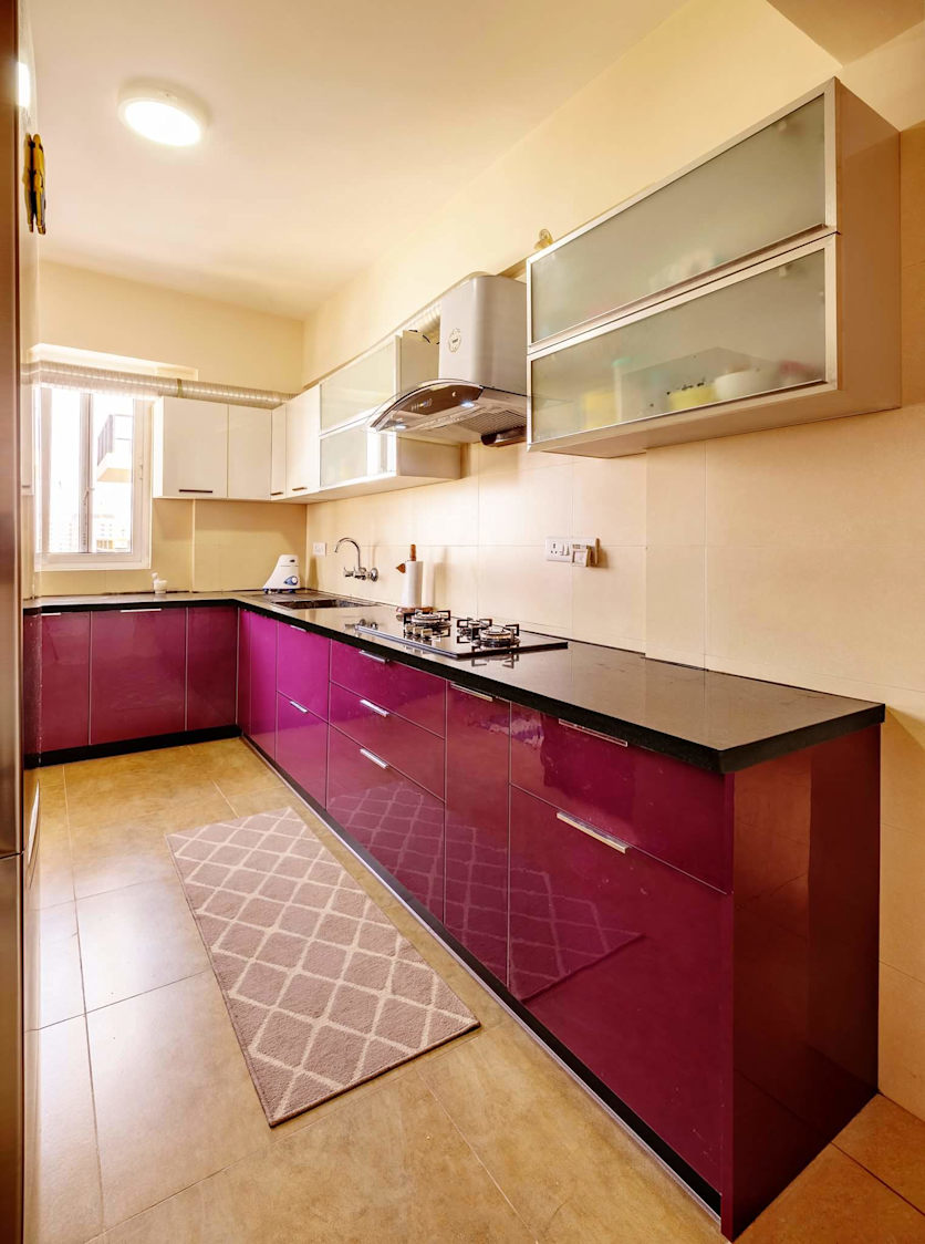 Maroon L shaped kitchen by Mehul Diwani