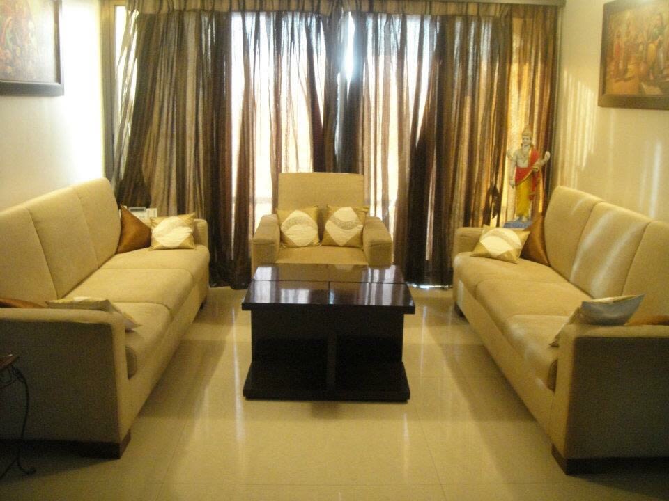 Living Room With Caramel Sofas and Wooden Center Table by Amish Rathod Living-room Modern | Interior Design Photos & Ideas