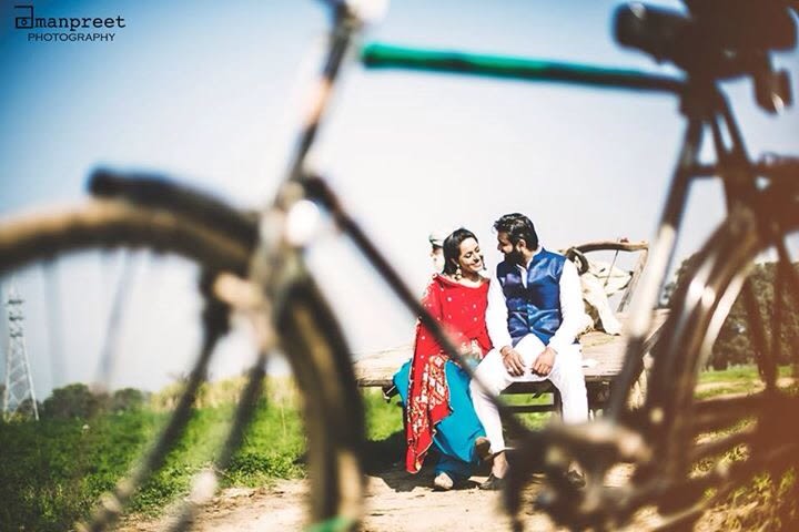 Bride and Groom To-Be Pose With Bicycle Prop by Amanpreet Kaur Wedding-photography | Weddings Photos & Ideas
