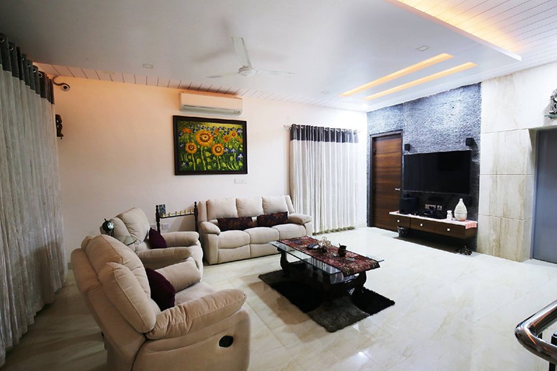 Living Room With Beige Cushioned Sofa And Glass Table by Nilesh Jain Living-room Contemporary | Interior Design Photos & Ideas