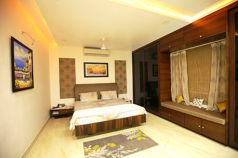 Low Rise Bed With Dark Walnut Wooden Wardrobe by Kraftworks Pvt. Ltd. Bedroom | Interior Design Photos & Ideas