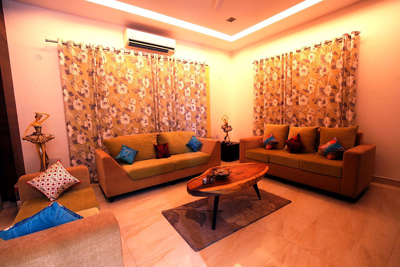 Mustard And Brown Lawson Sofas And Wooden Table by Kraftworks Pvt. Ltd. Living-room | Interior Design Photos & Ideas