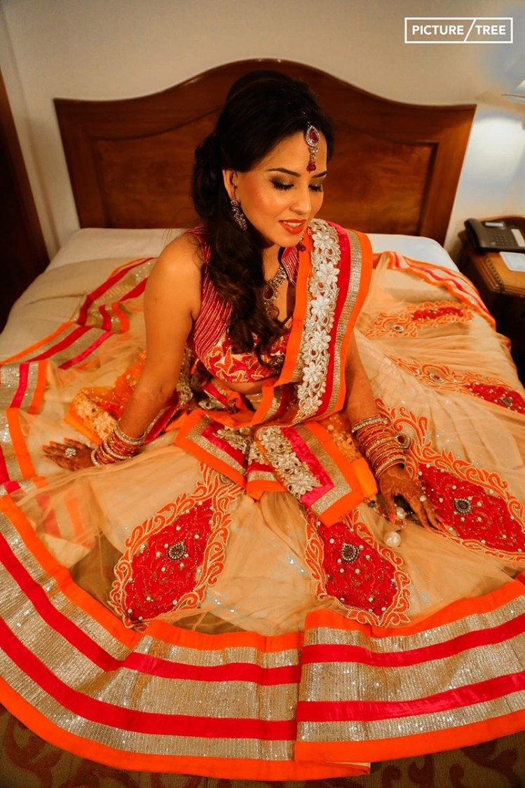 The bride looking elegant in her orange lehenga by PictureTree Wedding-photography | Weddings Photos & Ideas