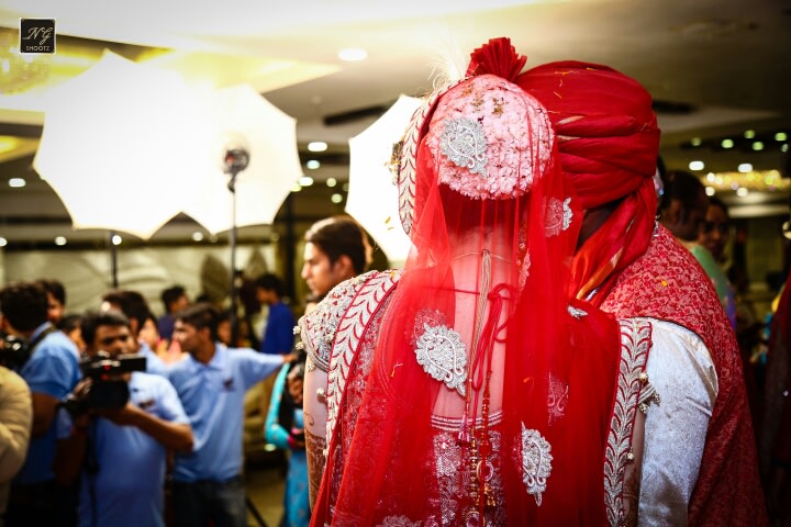 The couple overlooking the ceremony while getting clicked by NG Shootz Wedding-photography | Weddings Photos & Ideas
