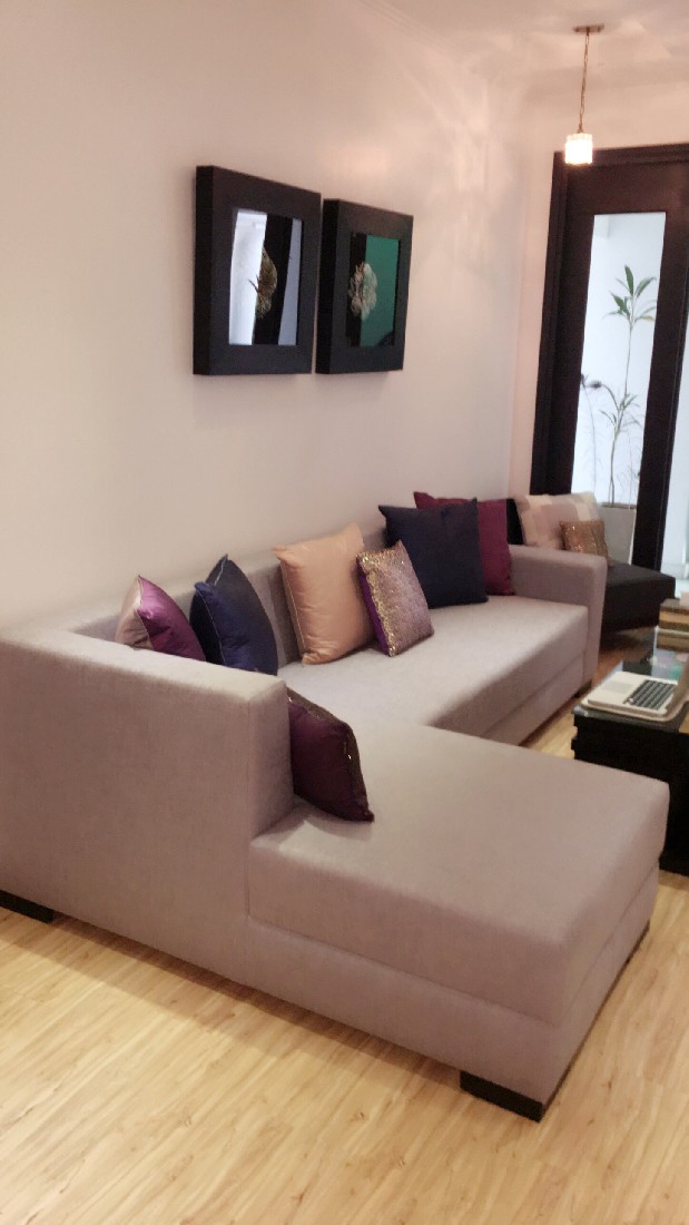Beige Sectional Sofa and Light Brown Shaded Wooden Vinyl Floor by Sakshi Gugnani Living-room Modern | Interior Design Photos & Ideas