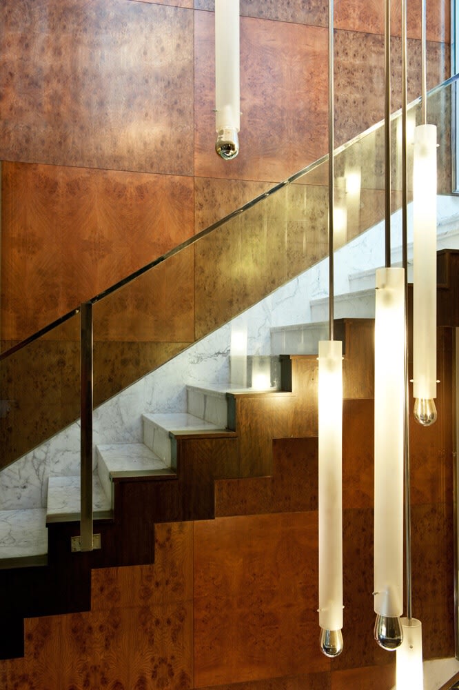 Wooden Staircase With Glass Enclosure and Sleek Hanging Pendant Lamps by Sakshi Gugnani Indoor-spaces Modern | Interior Design Photos & Ideas