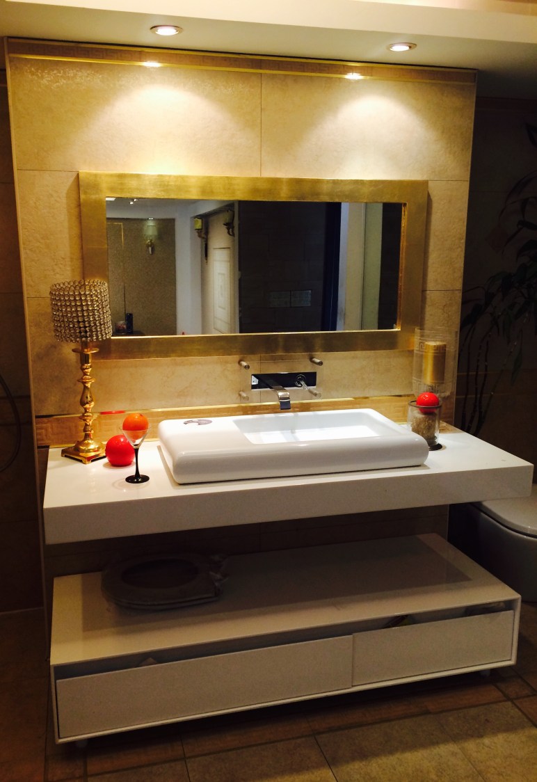 Golden Theme Bathroom With White Sanitaryware by Sakshi Gugnani Bathroom Modern | Interior Design Photos & Ideas