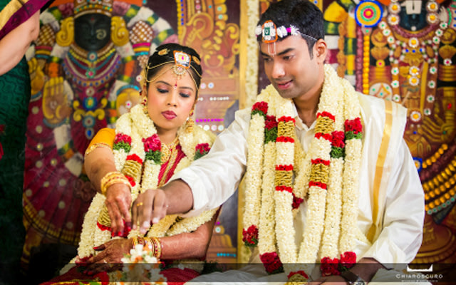 The couple indulging in the indian wedding traditions by Chiaroscuro Wedding and Art Studio Wedding-photography | Weddings Photos & Ideas