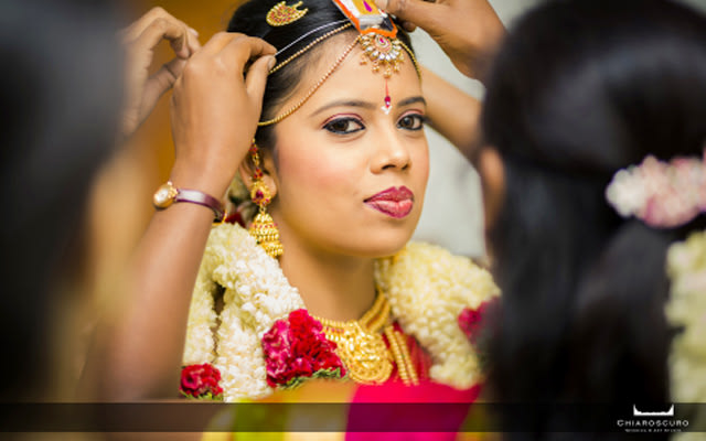 The bride making sure her maang tikka is perfect by Chiaroscuro Wedding and Art Studio Wedding-photography | Weddings Photos & Ideas