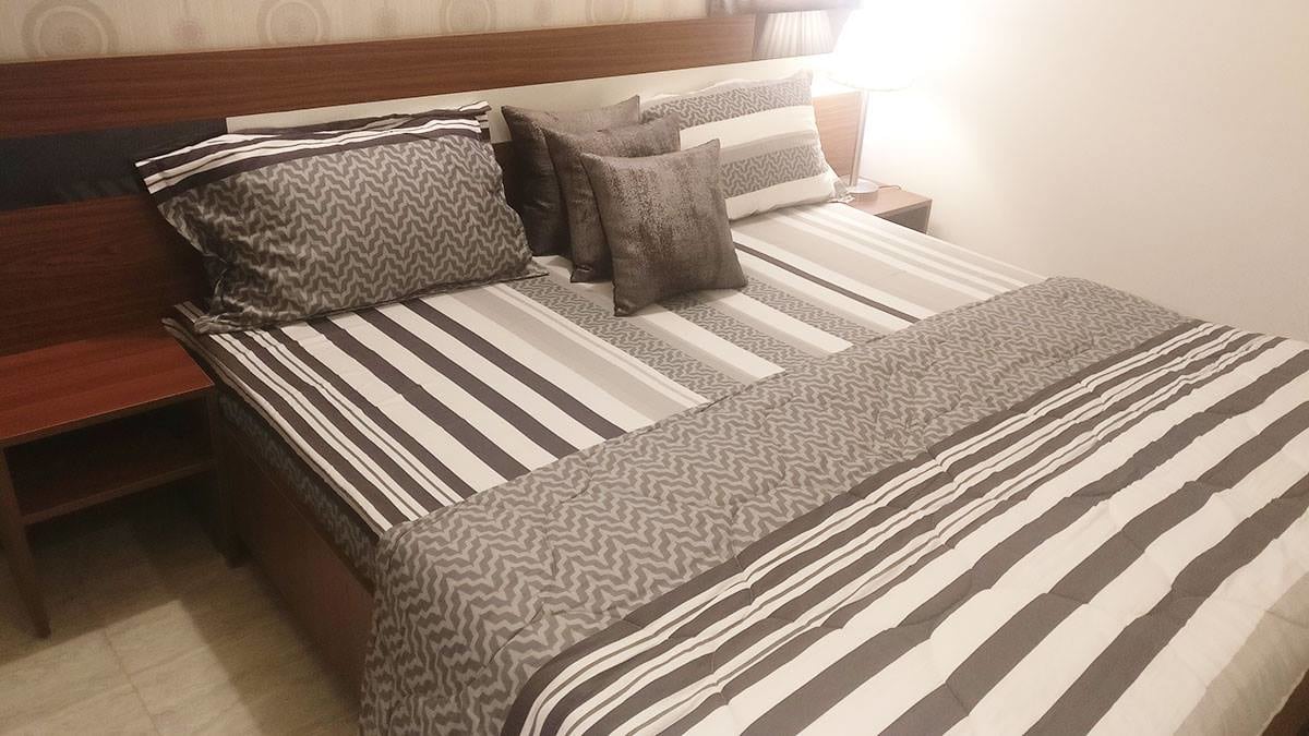 King sized bed with wooden polished headboard and compact side table by Interior Wizards Bedroom Contemporary | Interior Design Photos & Ideas