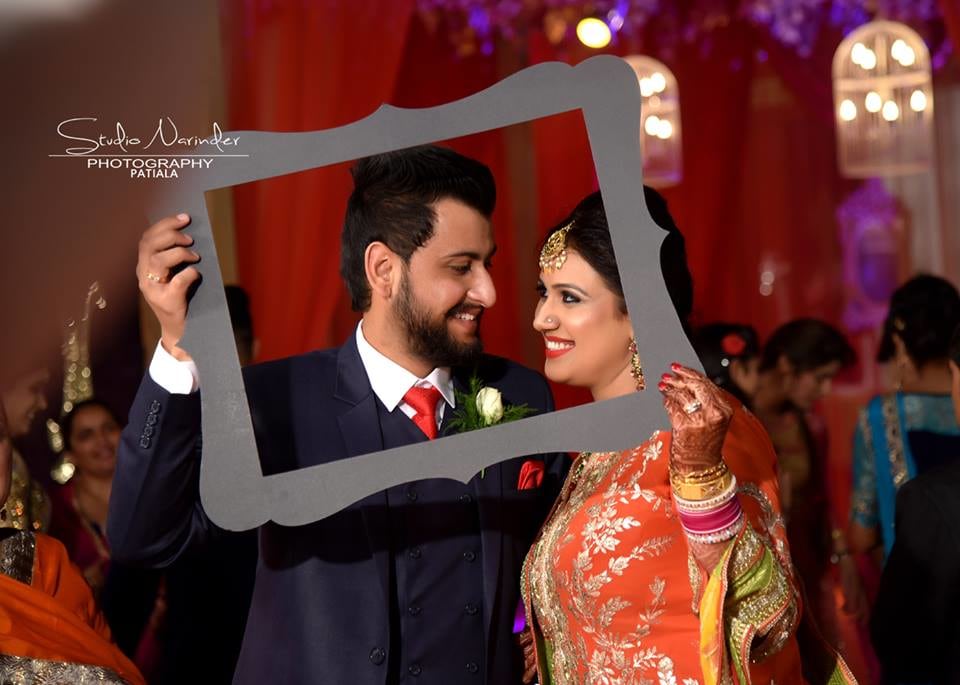 Conventional Punjabi Couple Holding A Black Curved Frame For Wedding Shoot by Sourab Sharma Wedding-photography | Weddings Photos & Ideas
