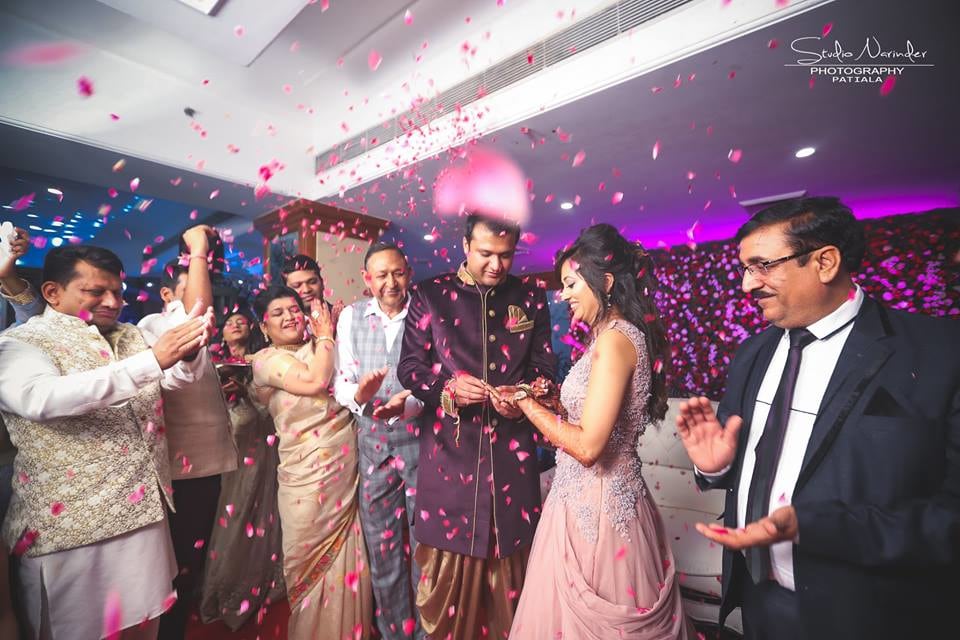 Candid Shot Of Bridegroom Amidst Ring Ceremony Being Showered By Rose Petals by Sourab Sharma Wedding-photography | Weddings Photos & Ideas