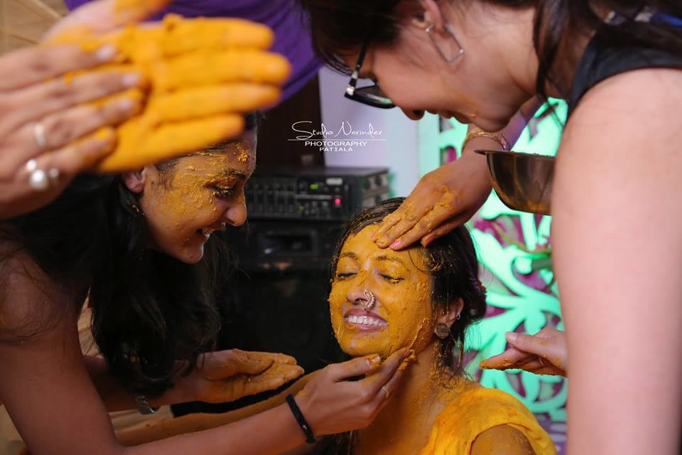 Candid Shot Of Bride To Be Being Applied Haldi By Family by Sourab Sharma Wedding-photography | Weddings Photos & Ideas