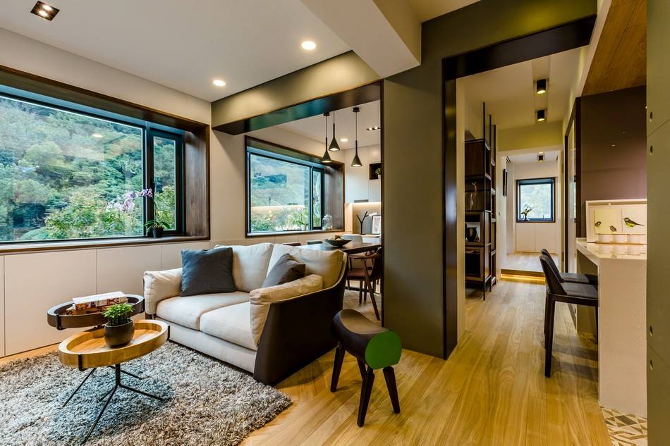 Premium living room with wooden flooring and sectional sofa and ceiling lights by Tanya Anand Living-room Modern | Interior Design Photos & Ideas