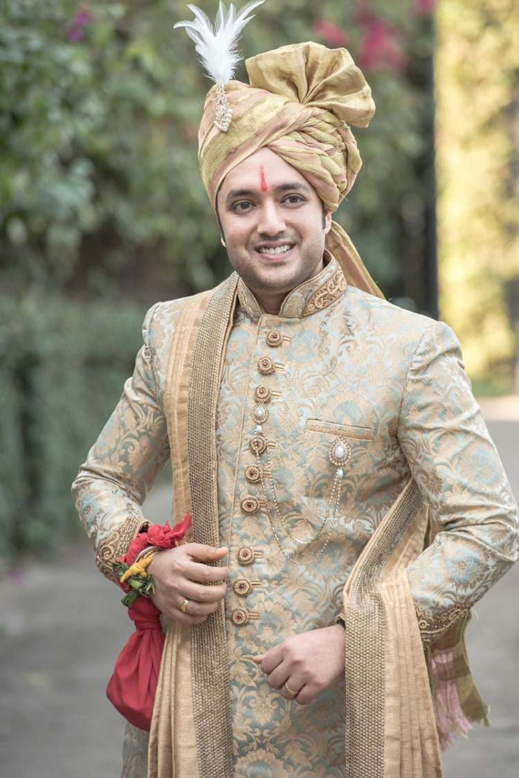 Golden Intricate High Collared Sherwani With Delicate Round Buttons Completing Its Look By Golden Turban With Feathered Kilangi Brooch by Nikhil Y. Bharane Wedding-photography Groom-wear-and-accessories | Weddings Photos & Ideas
