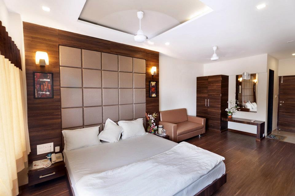 Bedroom With Wooden Flooring And White False Ceiling by ...