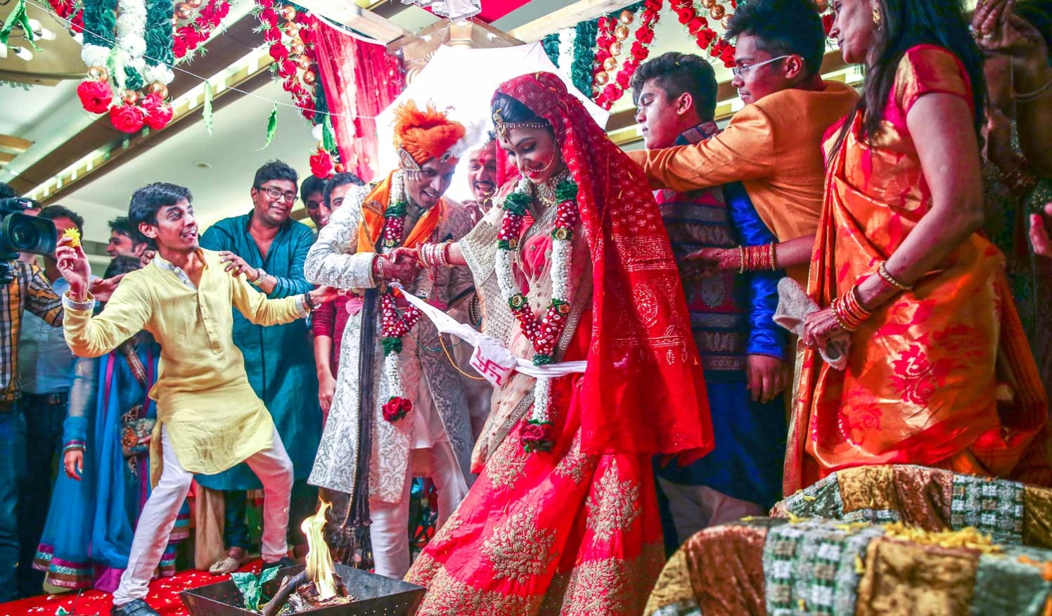 A candid picture of the family having fun during the wedding traditions. by Arya Arts Wedding-photography | Weddings Photos & Ideas