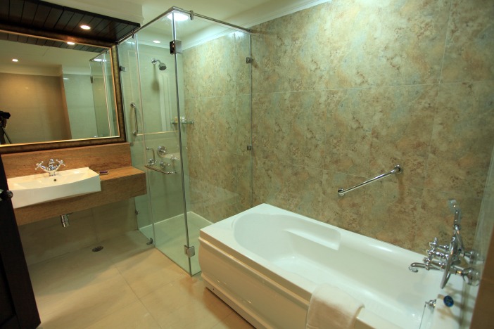 Glass Shower Stall And Bathtub In Bathroom by Vanshika Singh Bathroom Contemporary | Interior Design Photos & Ideas