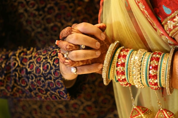 A bright display of jewelry as the couple holds hands together by Momento Perfecto Wedding-photography | Weddings Photos & Ideas