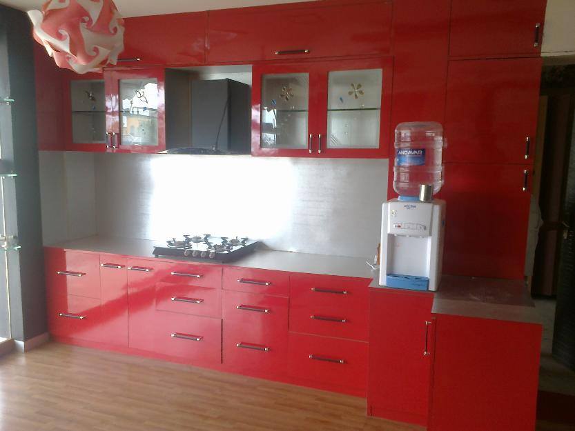 Red cabinets in kitchen with wooden flooring by Urban Geometry Modular-kitchen Minimalistic | Interior Design Photos & Ideas