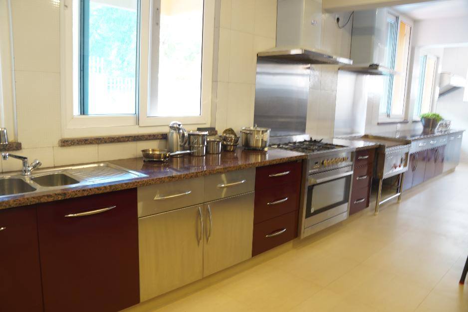 Open parallel kitchen with brown cabinets by Urban Geometry Modular-kitchen Contemporary | Interior Design Photos & Ideas