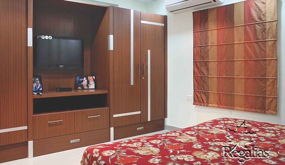 Wooden Finish wardrobe with Entertainment Unit by Regalias Interiors Bedroom Traditional | Interior Design Photos & Ideas