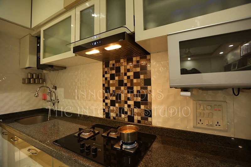 Parallel Modular Kitchen With Brown and Beige Mosiac Tiles and Brown Granite Slab by Innovations - The Interior Studio