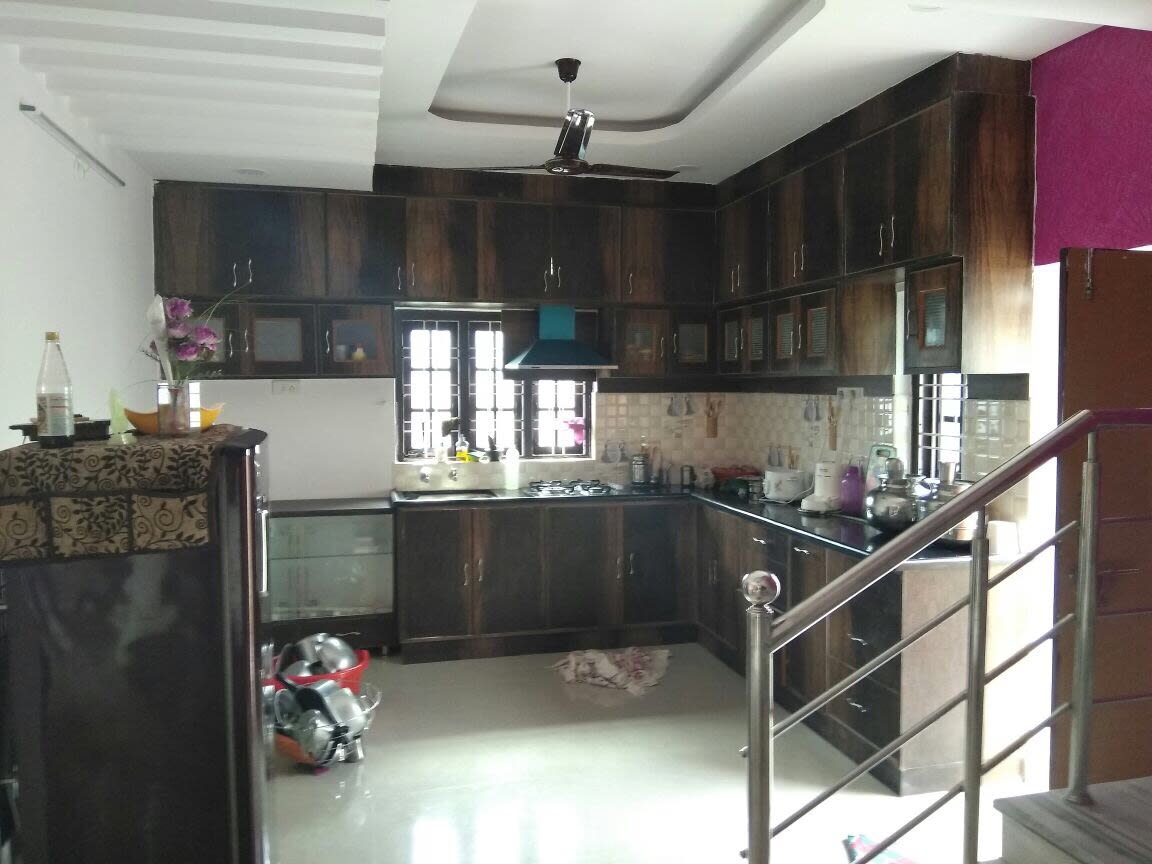 Brown L shaped kitchen with cabinets by Shiva Interiors Modular-kitchen | Interior Design Photos & Ideas