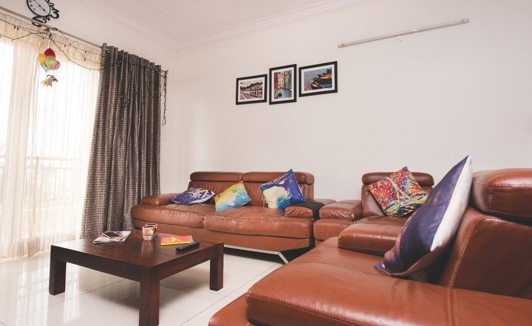 Living Room with Brown Leather Sectional Sofas And Wooden Center Table by Shyama Viswanathan Living-room Contemporary | Interior Design Photos & Ideas